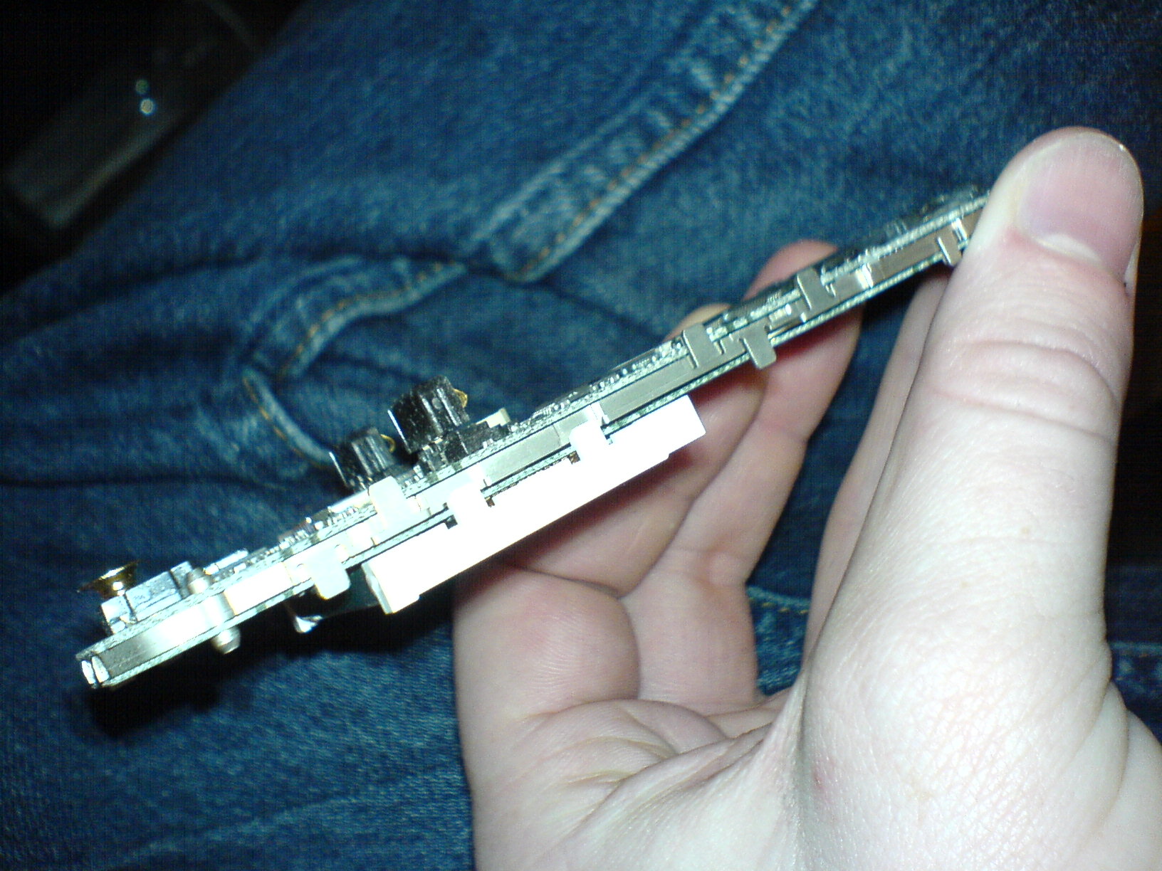 a man holding a partially broken computer memory board