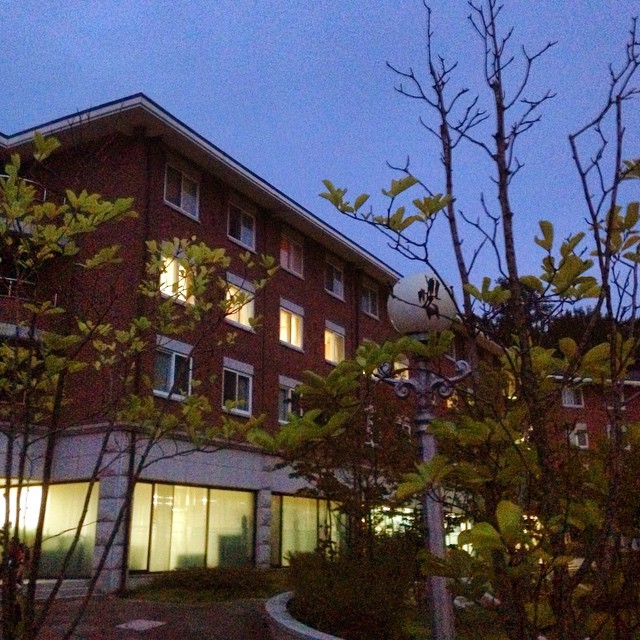 outside view of a building at dusk with a pathway to the front