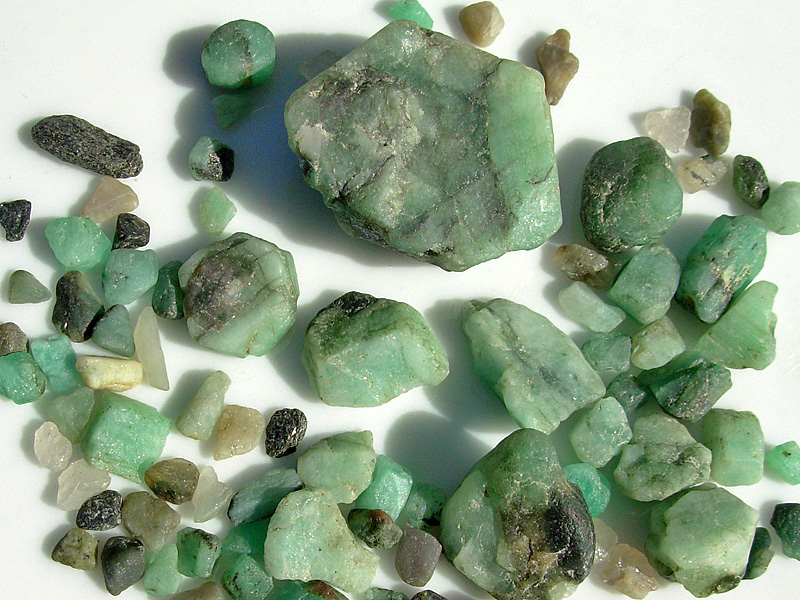 many green stones with different colors on a table