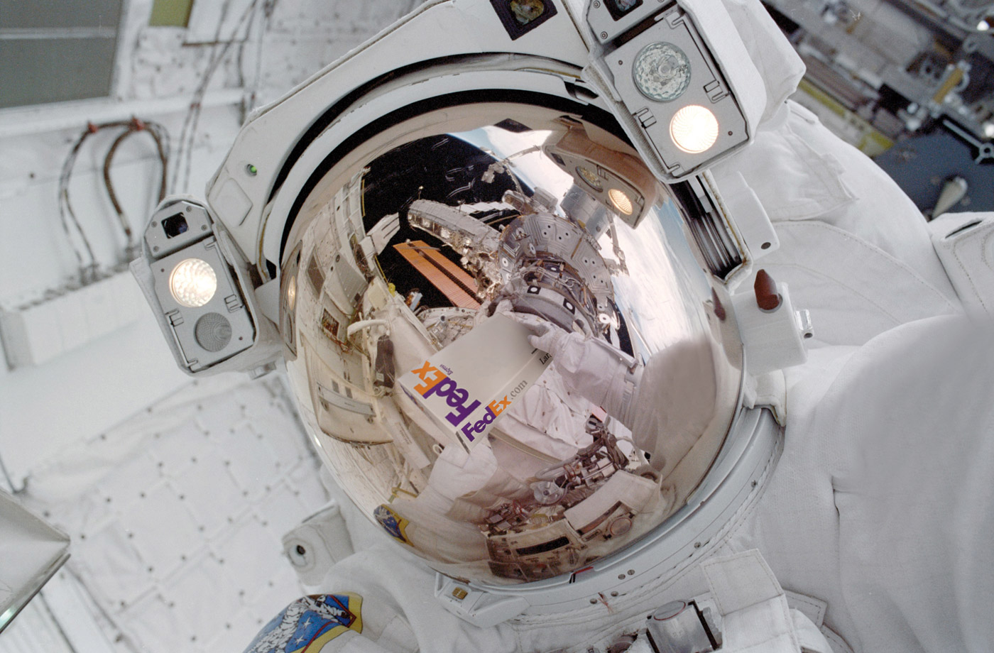astronaut's reflection as he floats in the space shuttle