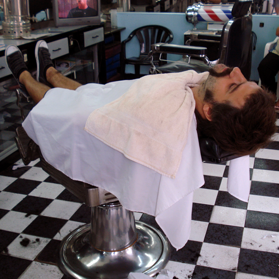 a man laying on top of a barber chair