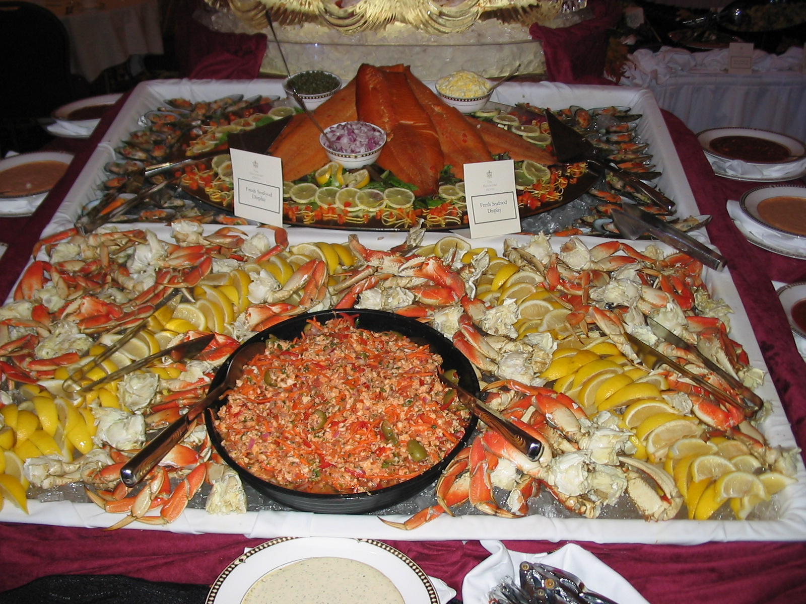 the buffet spread is full of many seafood, seafood dishes and dips