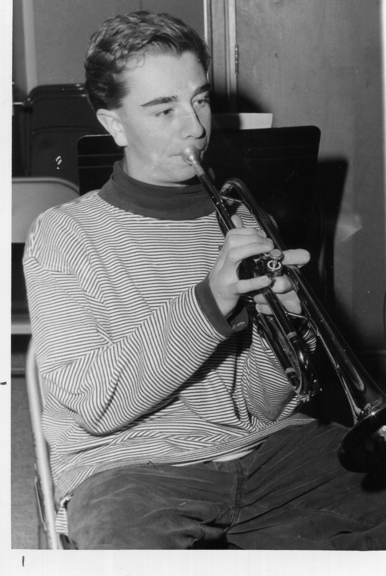 a man is playing an instrument while sitting down