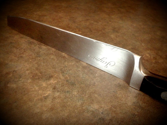 a metal knife sitting on top of a counter