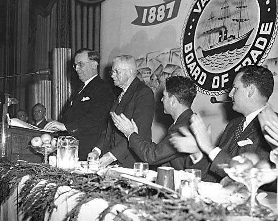 black and white pograph of several men at a meeting