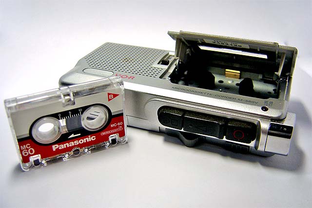 a cassette player with a case and plugged in