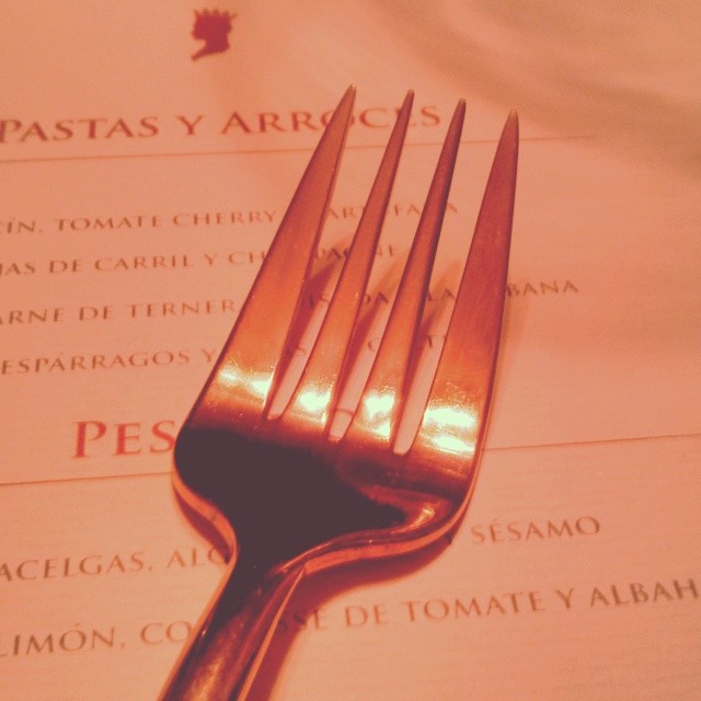 a knife and fork resting on a menu