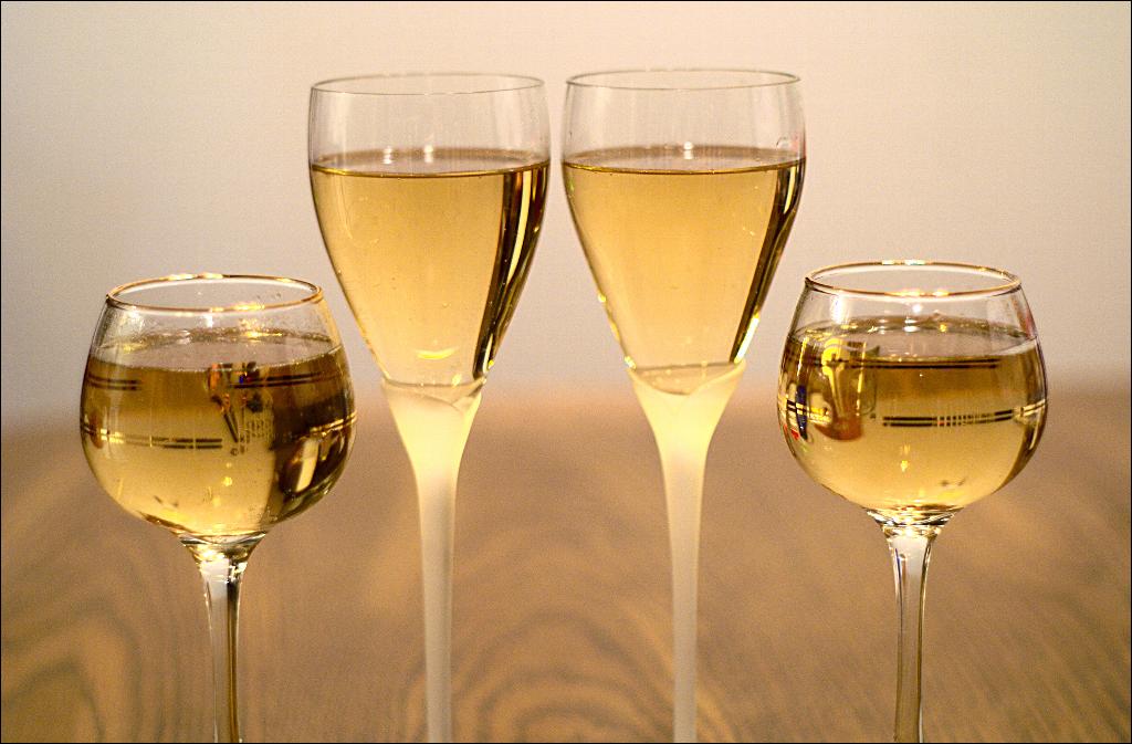 glasses of wine on a table with some white wine