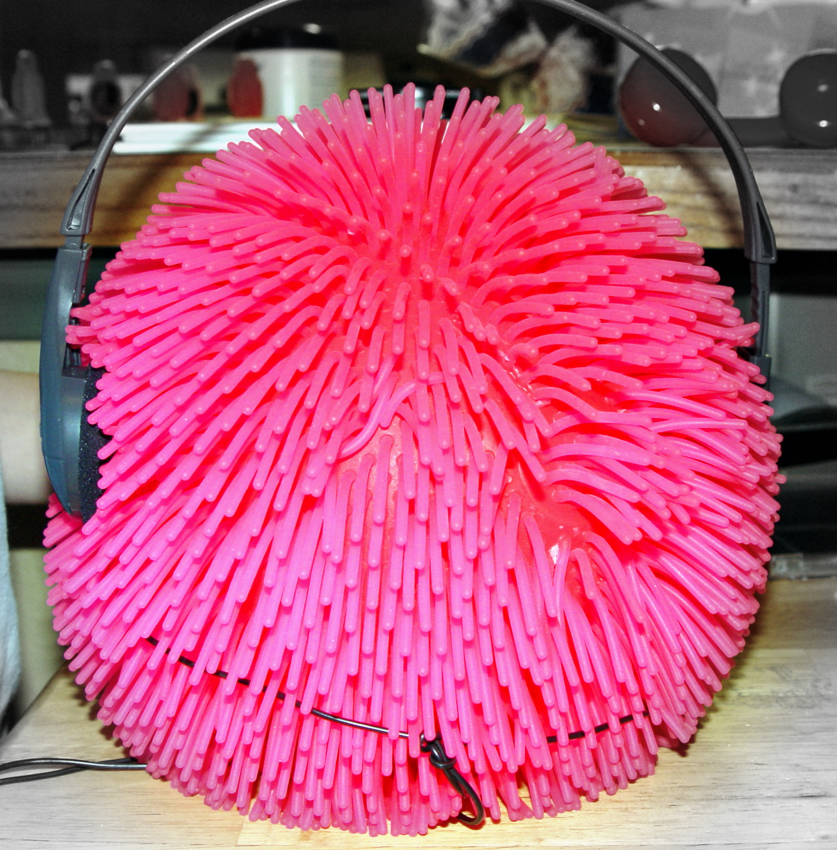 a pair of headphones laying on a piece of pink paper