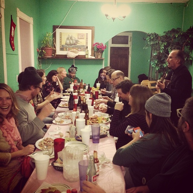 people sit at a long table to have a meal