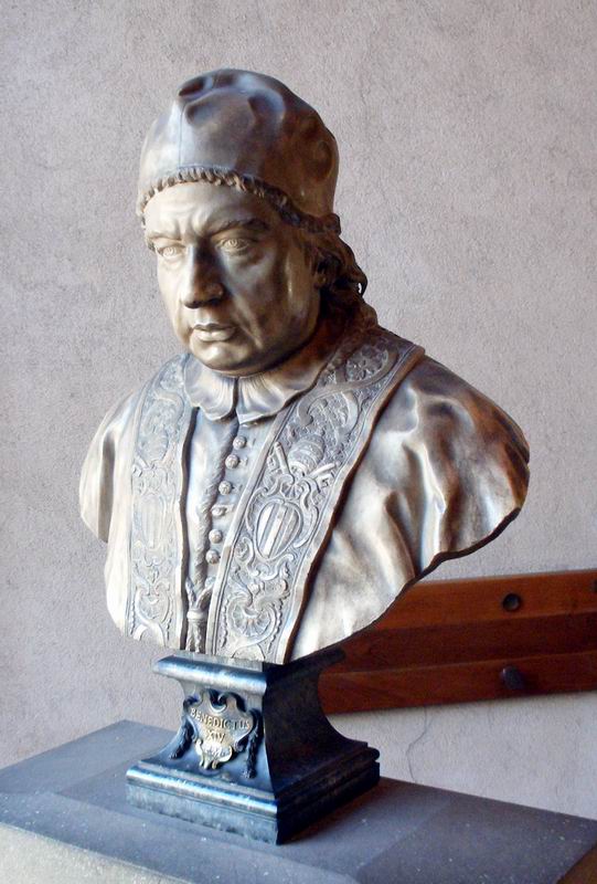 a bust of a man wearing a priest robe