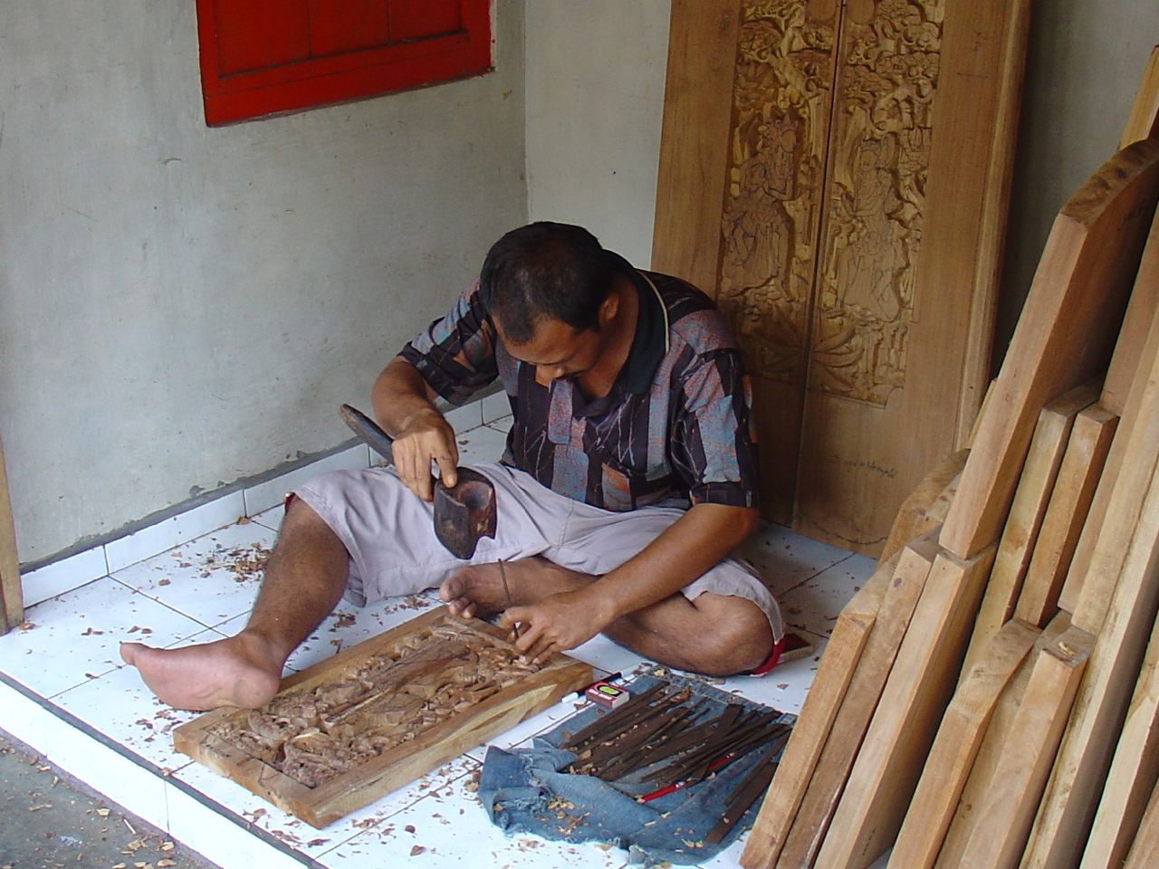 man sitting on white tile  wood with scissor