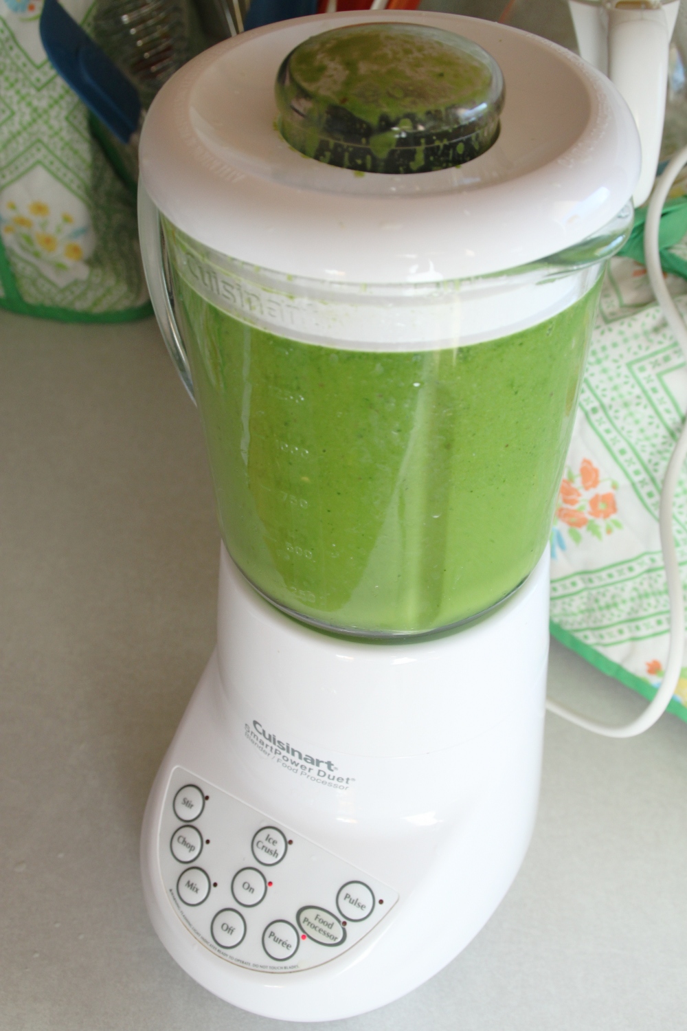 a blender is filled with green powder