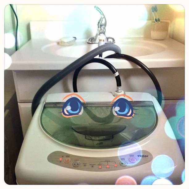 an electric washer with the eyes of a cartoon character painted on it