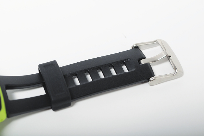the black strap of a watch with green rubber