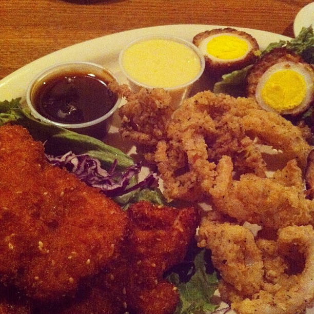 fried food with two sides, a salad, eggs and lettuce on the side