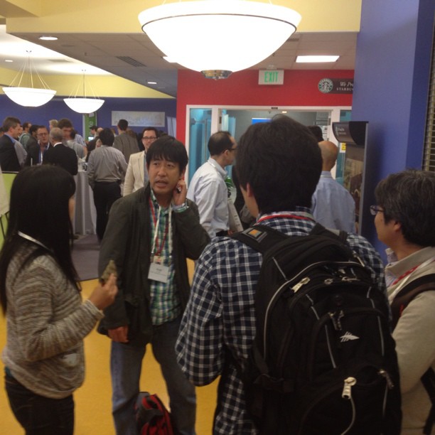 a crowd of people standing inside of a room