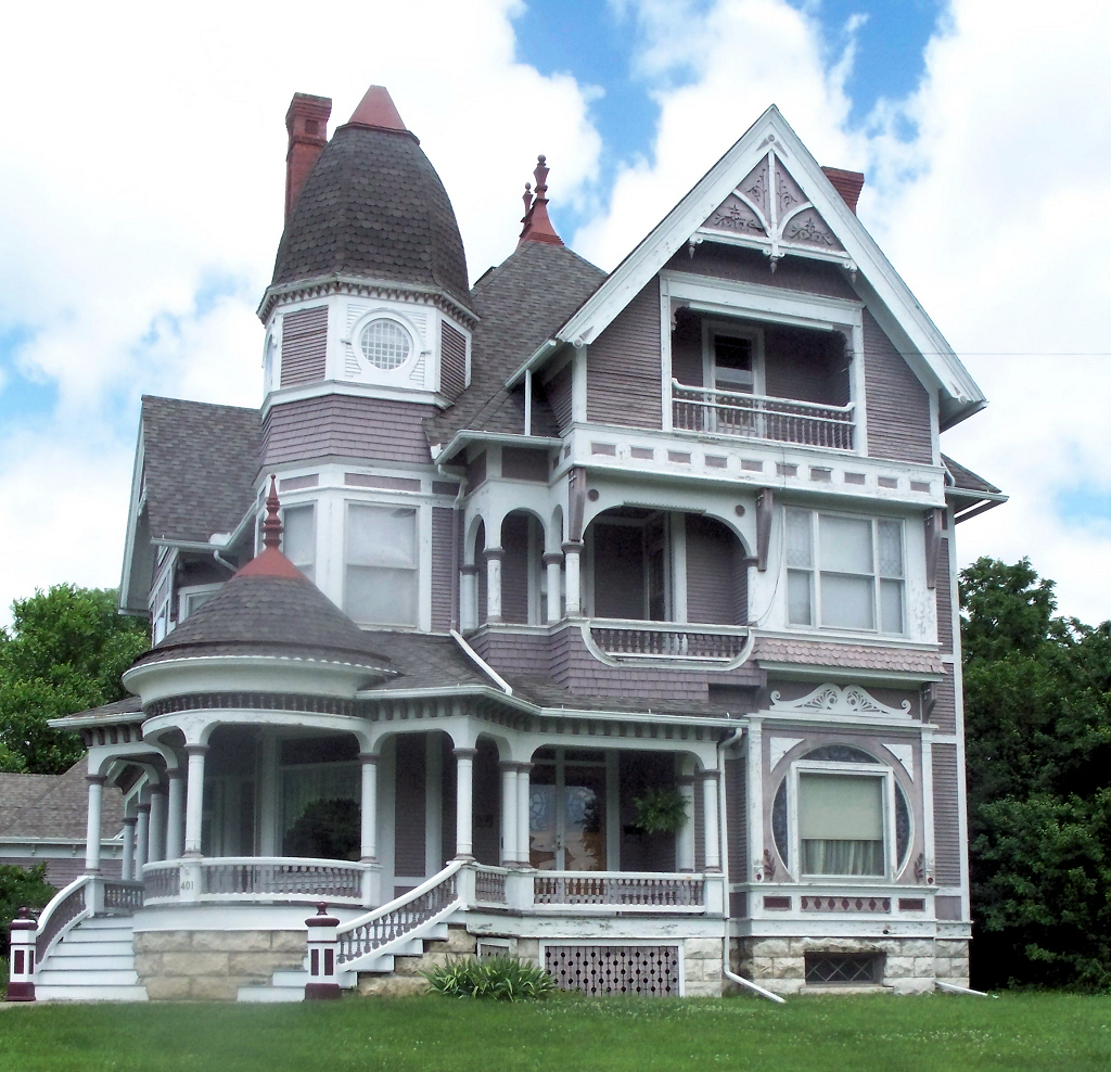 an ornate victorian home with a view of the ground