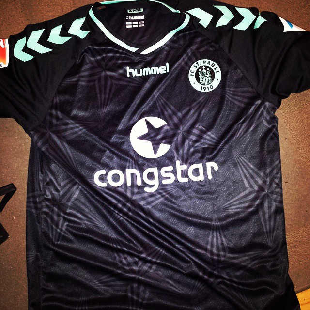 black soccer jersey with logo on the back