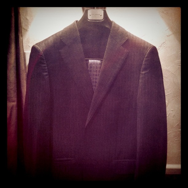 a suit jacket hanging up on the wall