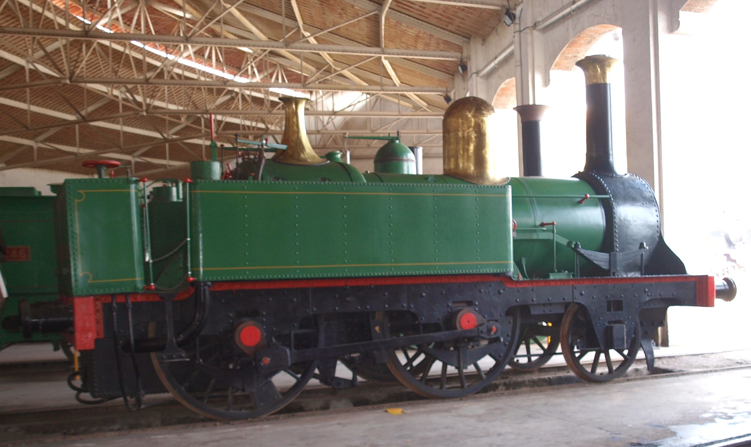 a train sitting on the tracks inside a building