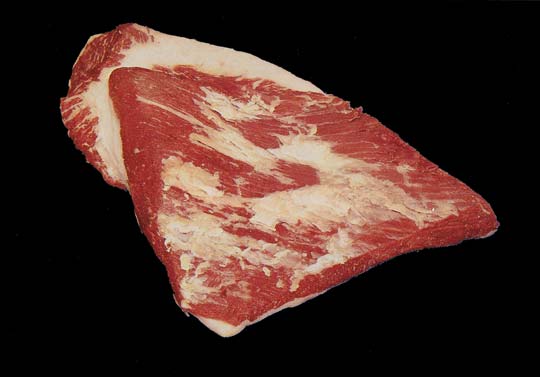 raw meat on a black background is depicted