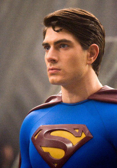 a young man dressed as superman in a blue suit