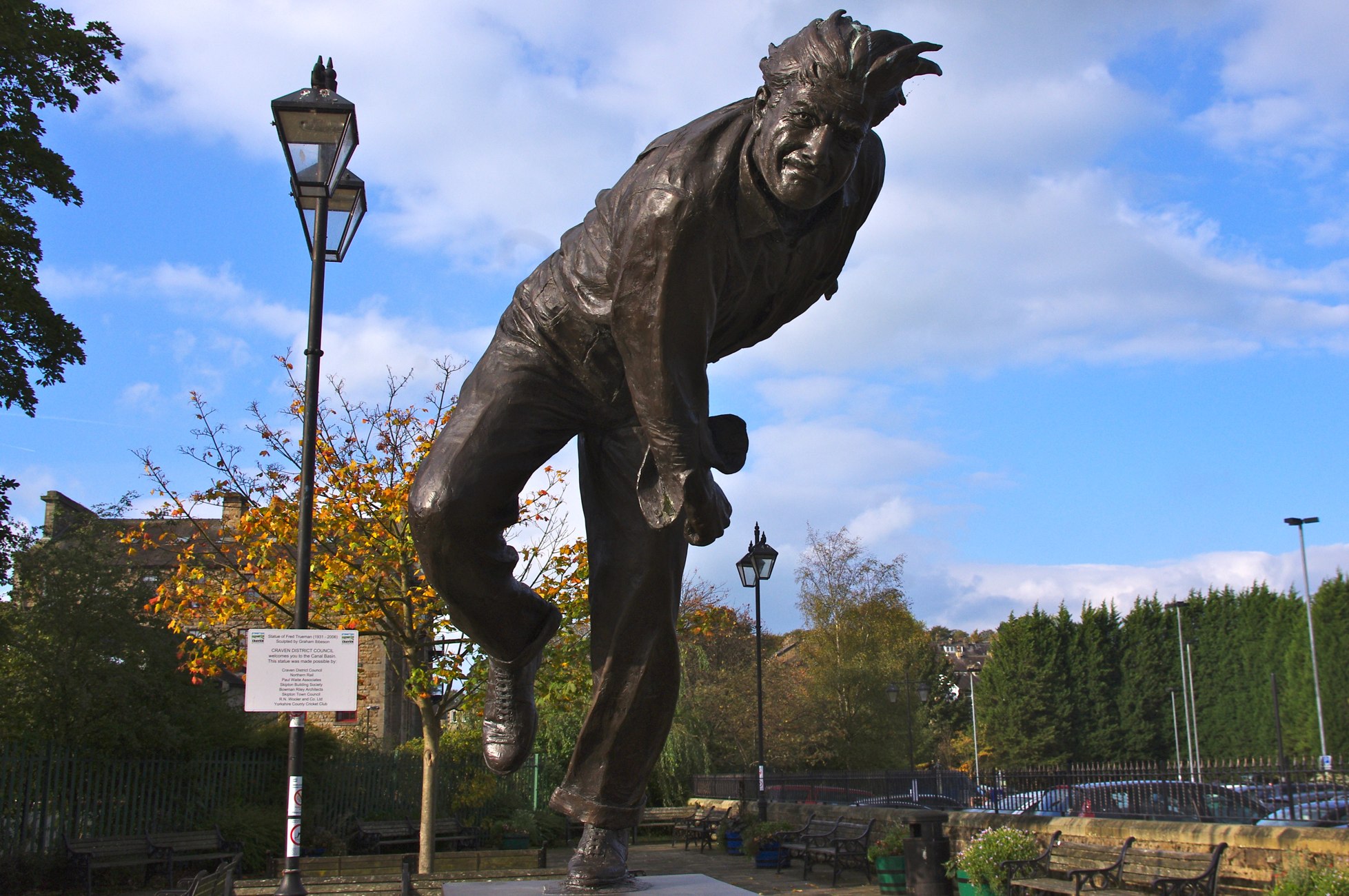 a statue is shown in a park area