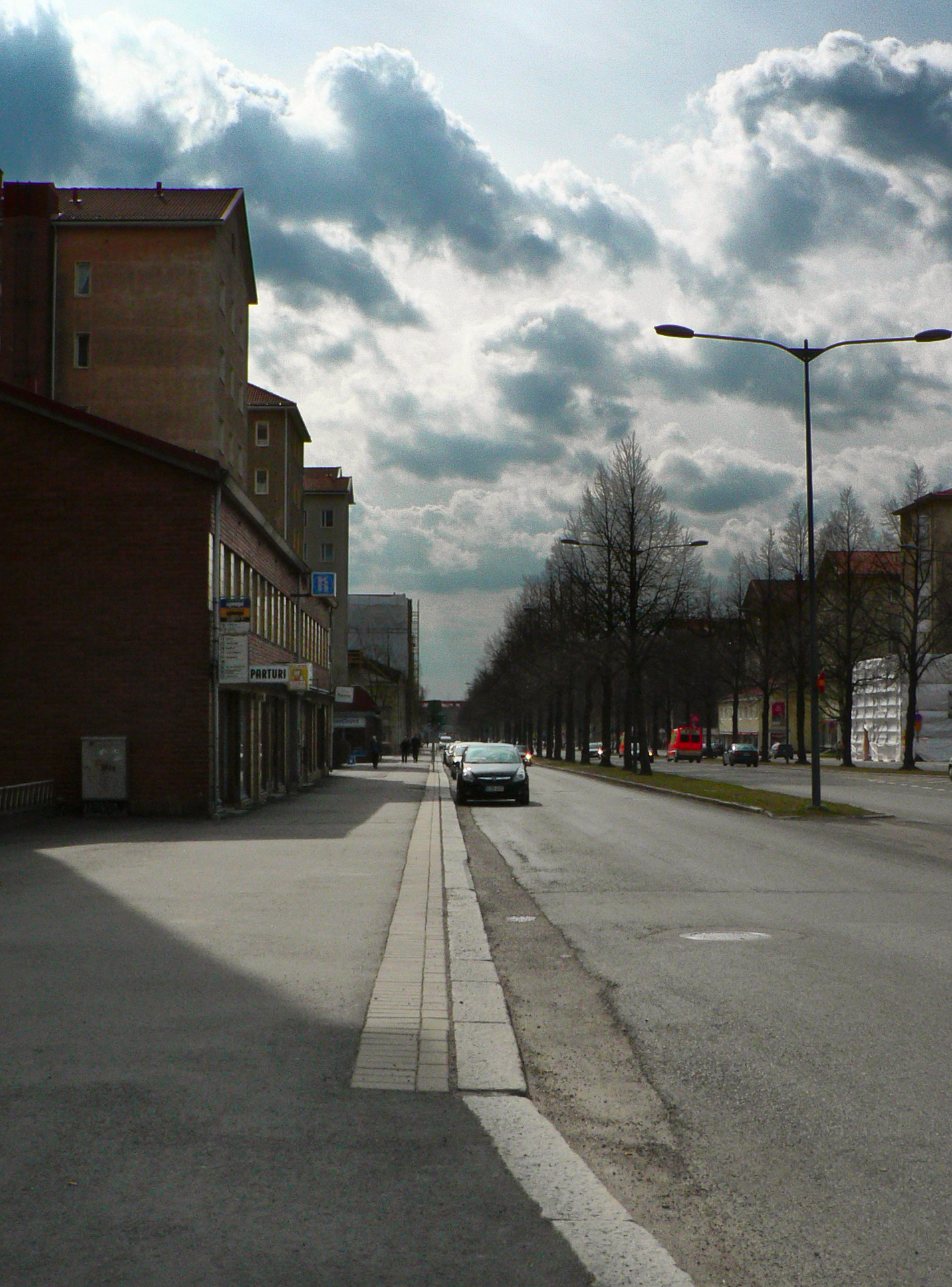 an empty street in front of a building and streetlight