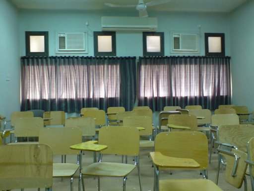 the classroom with many desks in front of a window