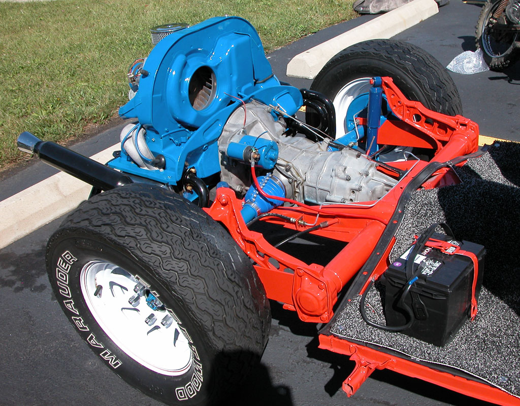 a blue and red racing car with a engine in the back of it