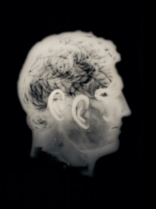 a person's head in the dark with smoke behind them