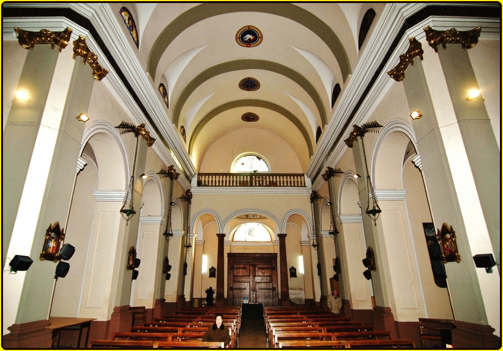 an inside view of a church with people seated