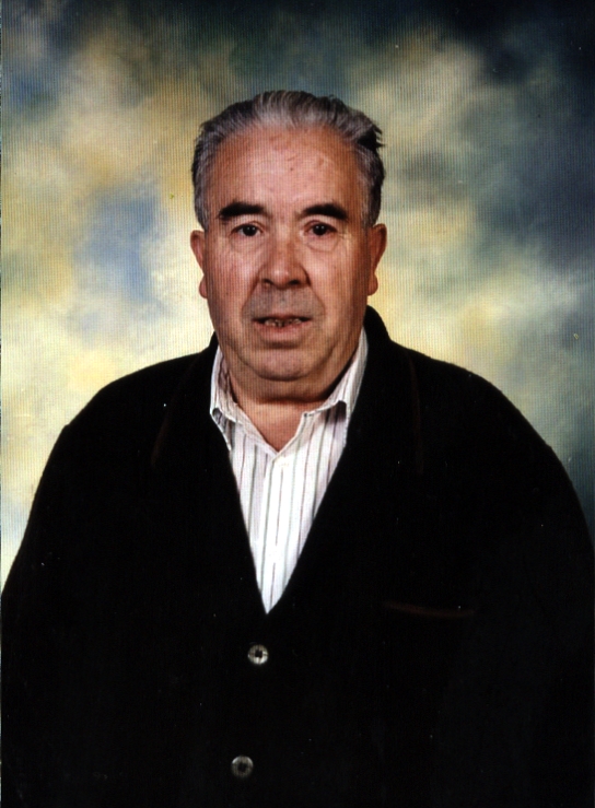 a man with grey hair posing for a portrait