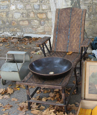 an antique black pan sitting on top of a wooden table