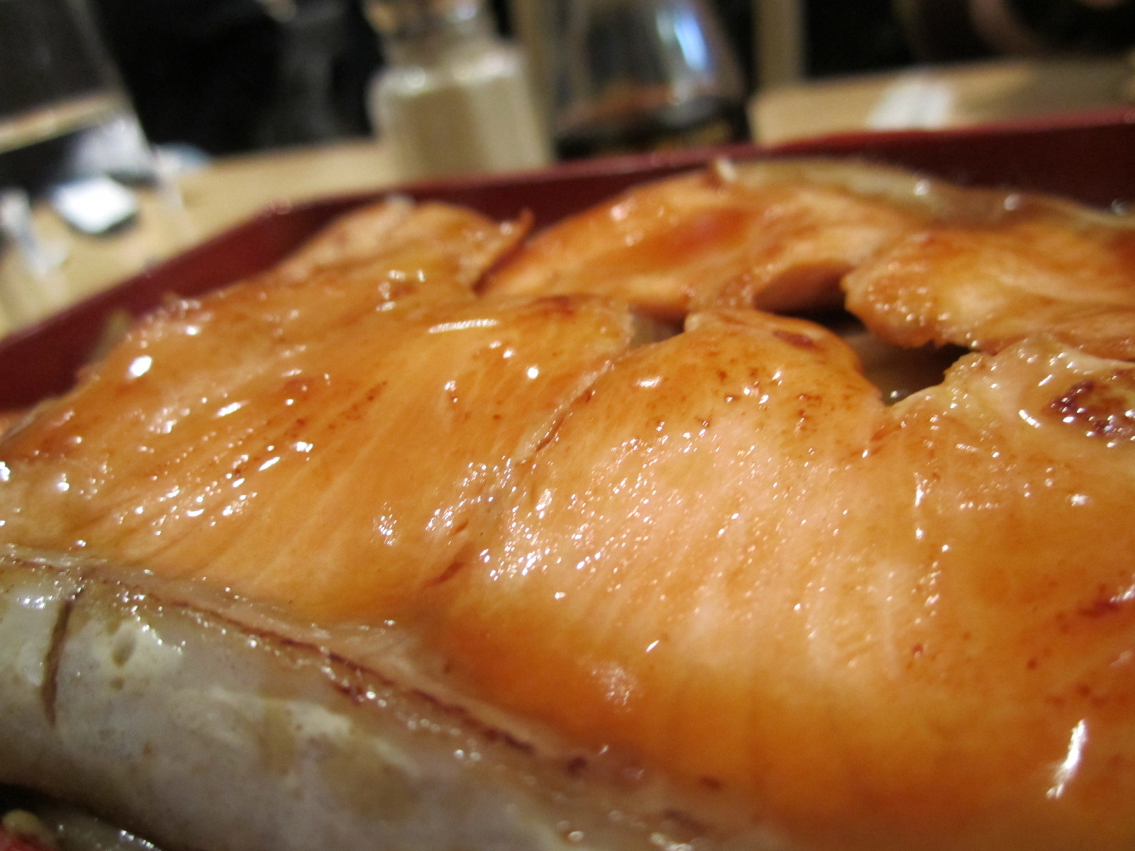 the meat with a sauce on top is displayed in a bowl