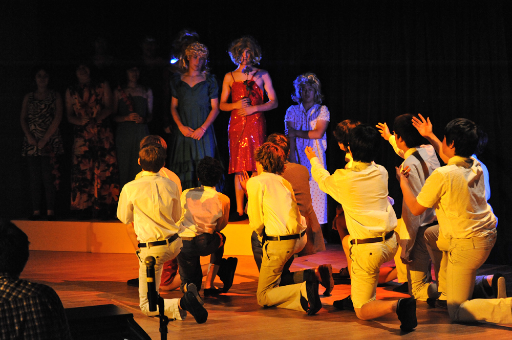 a crowd is sitting in front of a runway