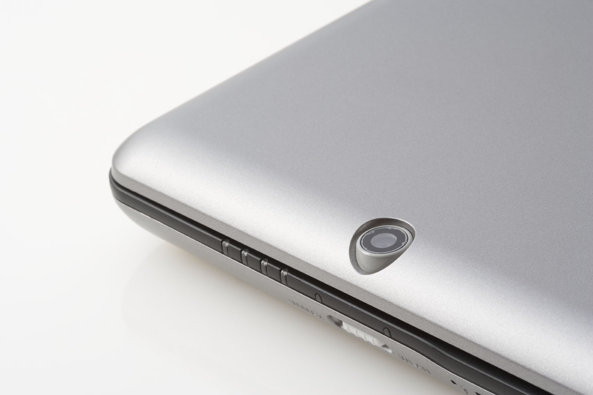 a silver laptop is on a white surface