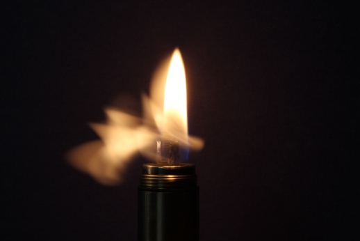 a lighter with flames coming out of the burner
