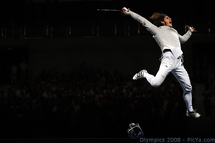 a man leaping into the air with a white shirt on
