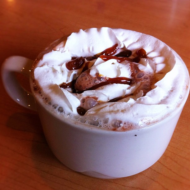 there is coffee with whipped cream in the cup
