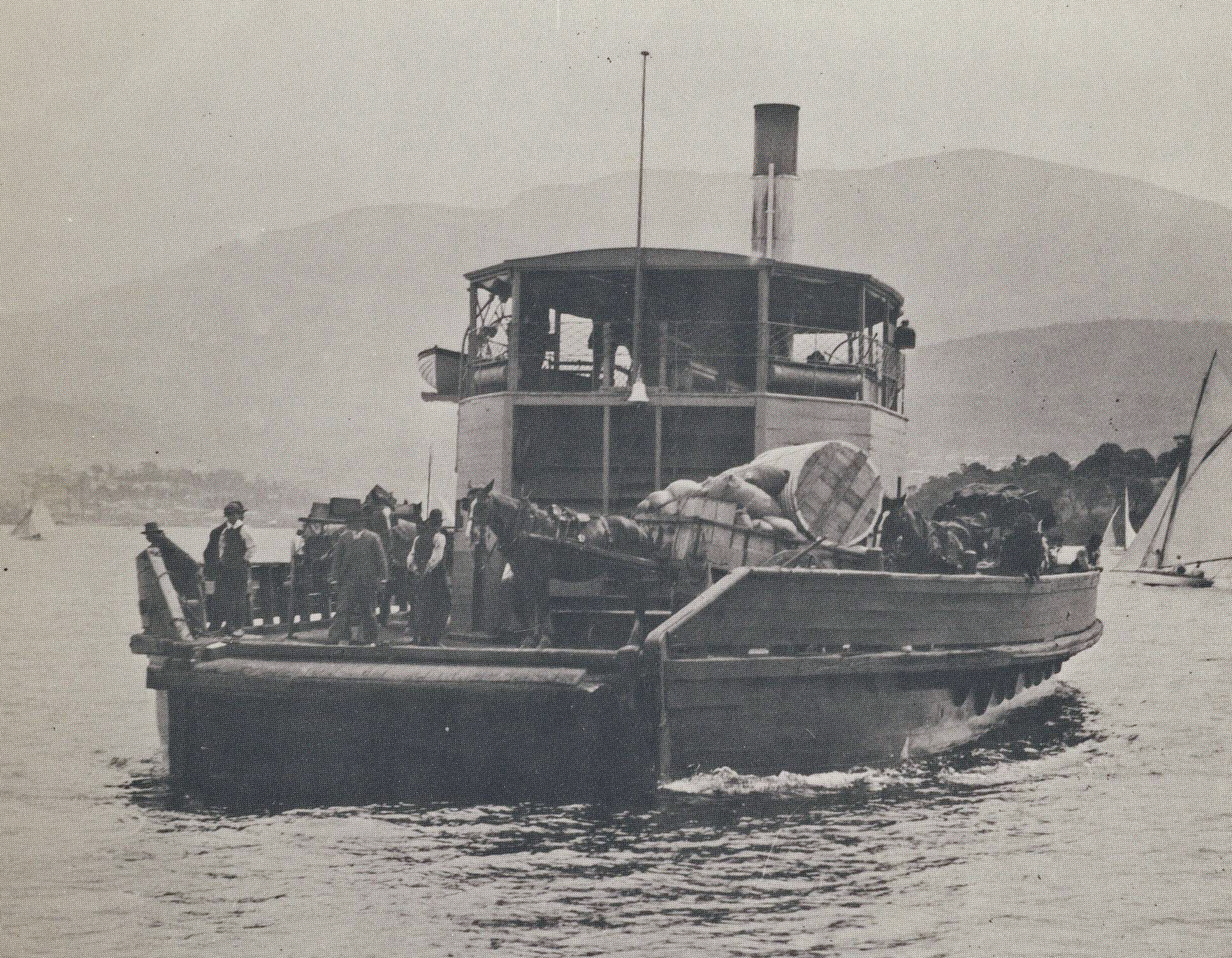 people stand on the edge of a boat in the water