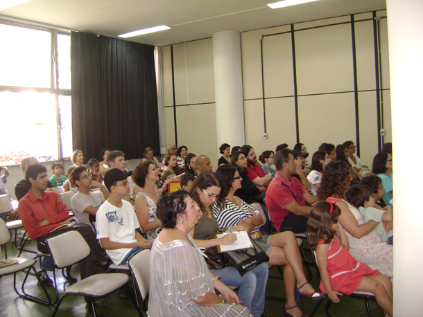 a large crowd sitting in rows at a lecture