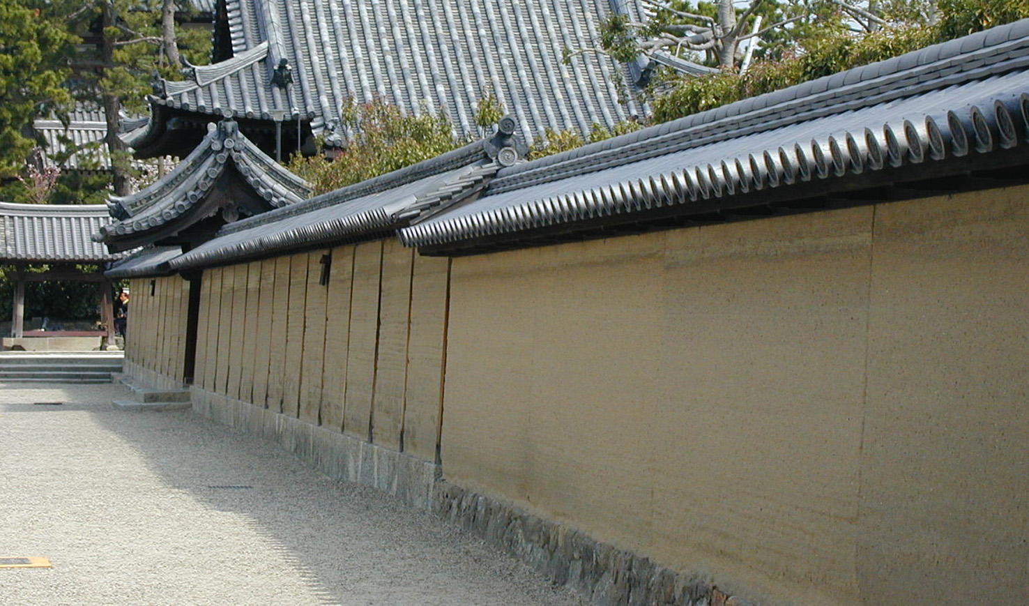 a close up of a wall with a building in the background