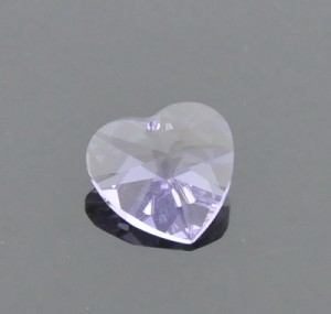 a white diamond heart that is floating in water