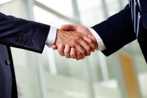 two people shaking hands with their hands on each other
