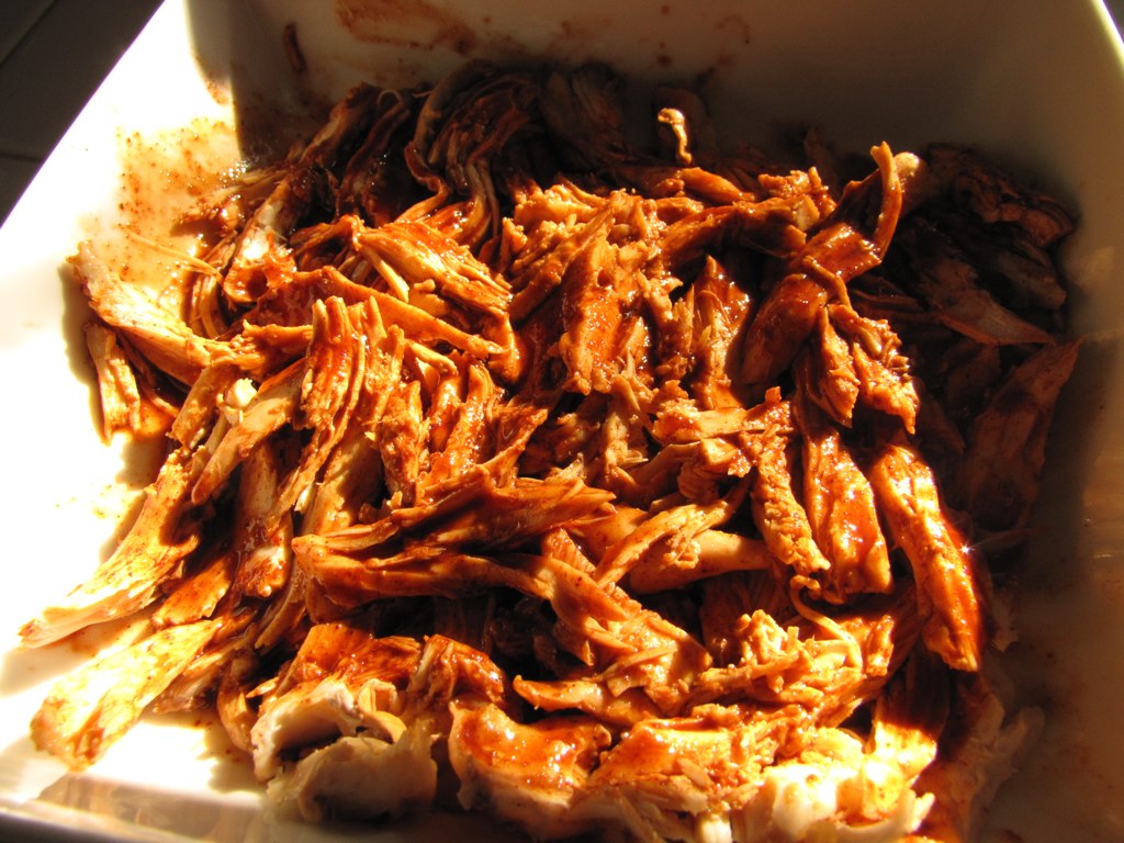 a close - up of shredded meat on top of a white dish