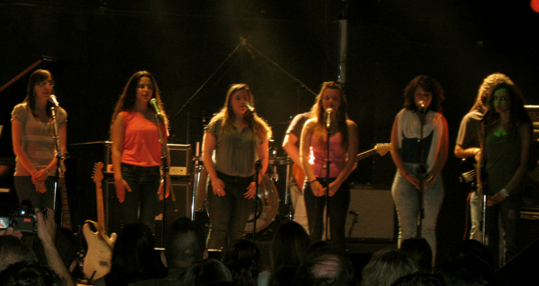 a group of girls that are standing on a stage