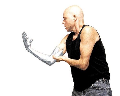 man standing with a silver glove on one hand