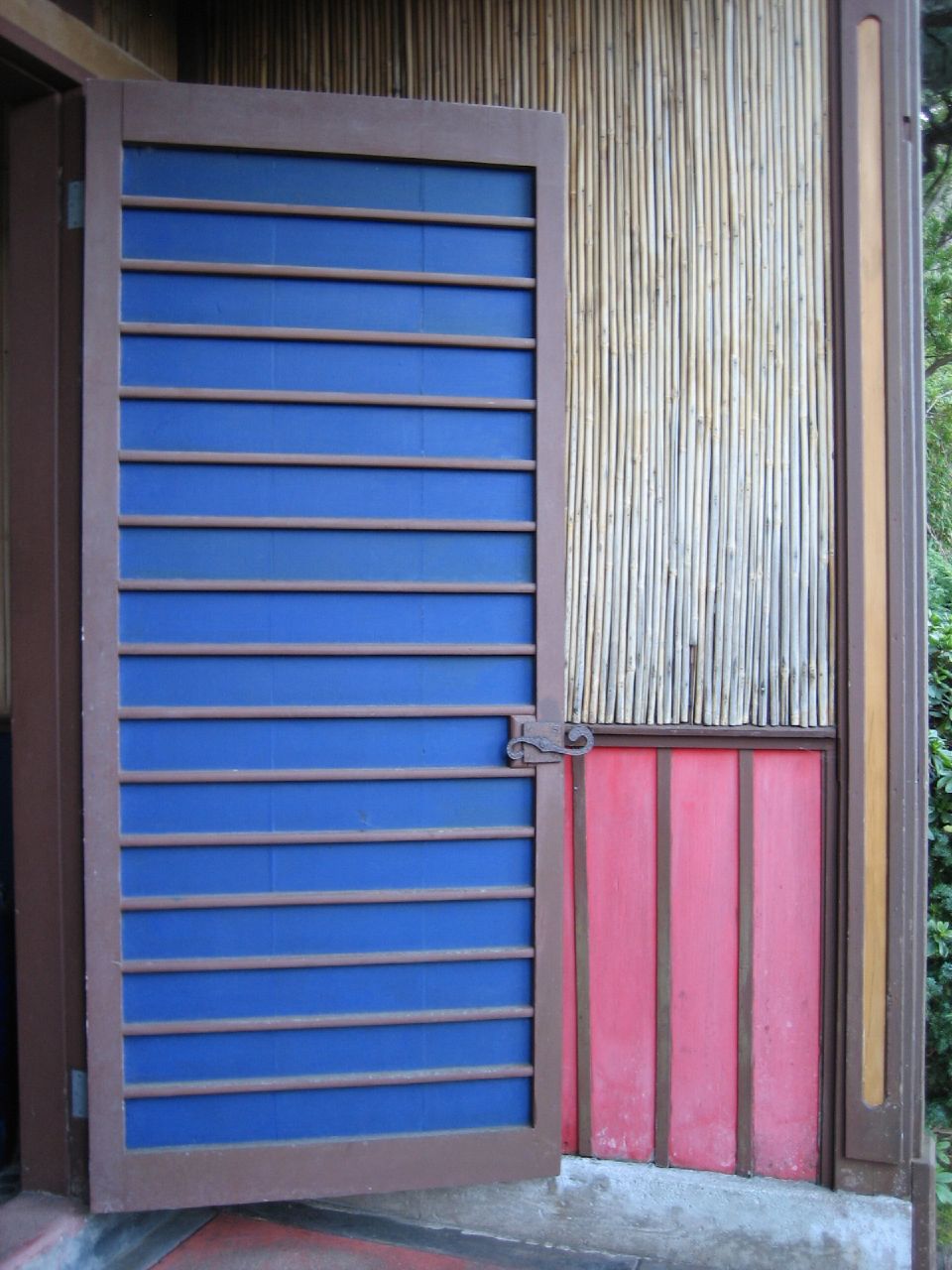 a wooden door that is outside with the doors open